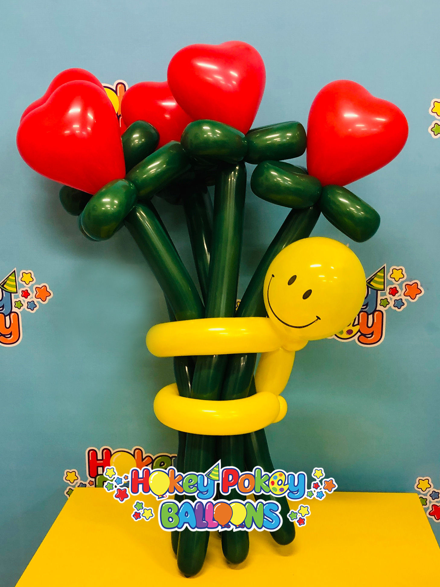 Picture of Heart Flower Balloon Bouquet with Smiley Guy (up to 21 flowers)